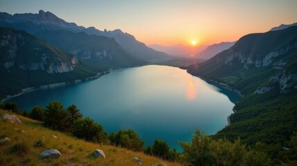 Lac de Serre Poncon in France at dawn, with mild, sunny summer conditions, seen from an aerial viewpoint.