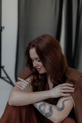 Obraz premium Aesthetic photo of attractive young woman in modern business suit with make-up and hair styling