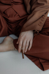 Aesthetic photo of attractive young woman in modern business suit with make-up and hair styling