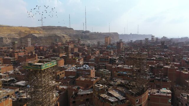 Brick Buildings And Rooftops Covered In Sorted Trash In Manshiyat Naser, Garbage City Of Cairo, Egypt. aerial shot