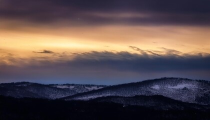 Obraz premium Snowy hills landscape with colorful sunset and moving clouds