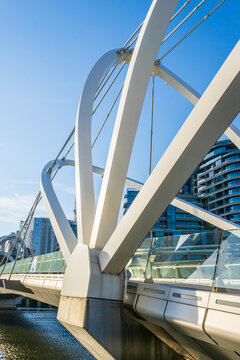 Close up of the arches of a modern inner city foot bridge.
