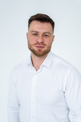 Fototapeta premium Confident man in white shirt. A confident man stands against a plain background, wearing a white shirt.