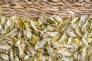 Freshly plucked tea leaves resting on a woven surface in a serene setting Generative AI