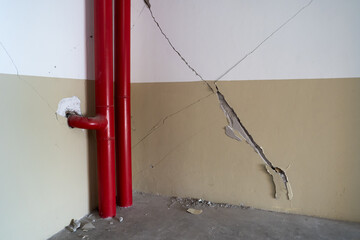 Crack broken concrete structure interior old ruin pipe paint cement, effected from earthquake and...