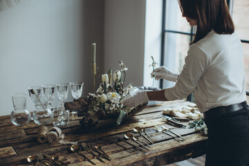 Country table decor with soft candles and natural elements creating an inviting atmosphere. The...