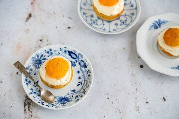 Lemon cupcakes with cream cheese, apricot and poppy seed. Cupcake in form of Fried Egg on a stone background. Easter eggs. Easter holiday and festive food.