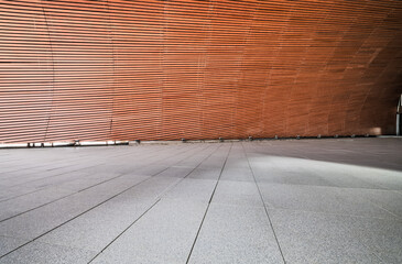 Empty stone floor and wooden wall background in modern architectural space.