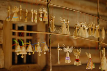 Charming handcrafted straw ornaments create a serene and nostalgic ambiance in a rustic setting.