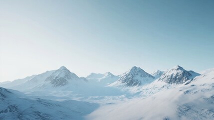Fototapeta premium Scenic view of a snow-covered mountain range under a clear winter sky