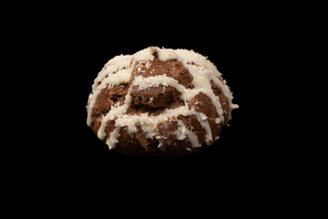 Profiteroles with coconut cream on a black background.