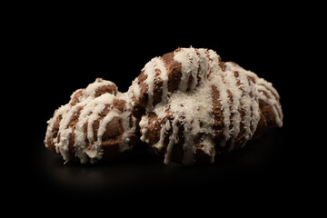 Profiteroles with coconut cream on a black background.