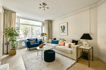 A contemporary living room featuring a comfortable sofa, vibrant decor, and natural light streaming...