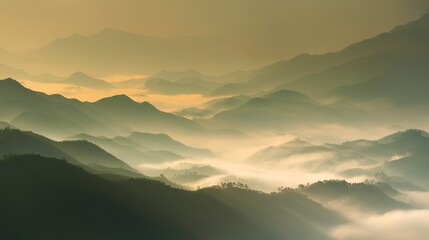 Fototapeta premium Aerial view of the foggy mountains at sunrise. The panorama of cascading mountains and a sea of clouds in the Chinese art style is reminiscent of National Park Award winning photographs.