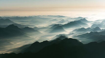 Fototapeta premium Aerial view of the foggy mountains at sunrise. The panorama of cascading mountains and a sea of clouds in the Chinese art style is reminiscent of National Park Award winning photographs.