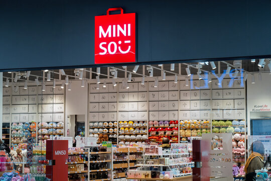MINISO store logo signboard above the entrance to the shop. MINISO store interior. Miniso is a Chinese low-cost retailer and variety store chain brand. Minsk, Belarus - March 28, 2025