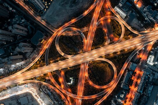 Aerial view of illuminated highway interchange at night.
