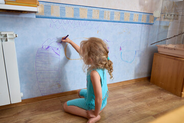 Young Girl Drawing on Wall with Crayon