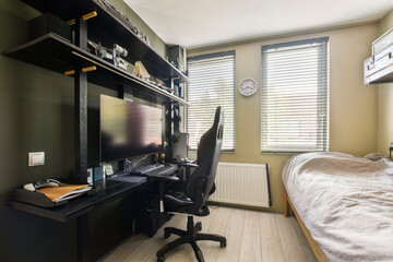 A sleek and modern home office setup featuring a computer workstation, natural light through the...