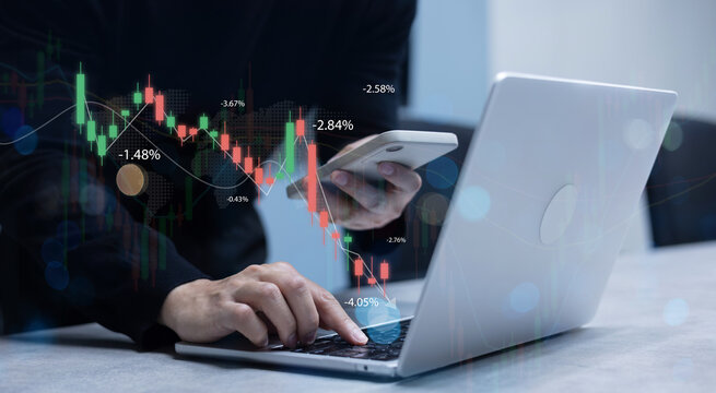 close up investor man hand check stock exchange market trend on laptop with virtual candlestick and price for trading and financial concept