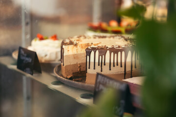 A beautiful cake decorated with chocolate on a pastry shop window.