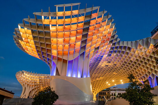 SEVILLE, SPAIN - OCTOBER 25, 2023 - Metropol Parasol illuminated at night, showcasing its iconic wooden lattice design and blending modernity with Seville's historic charm.