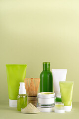 Matcha Skincare Cosmetics Background containing matcha powder, cream, serum, face mask, scrub, toner and moisturizer, natural clean beauty anti-aging skin care beauty trend