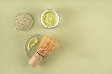 Matcha Skincare Cosmetics Background containing matcha powder, cream, serum, face mask, scrub, toner and moisturizer, natural clean beauty anti-aging skin care beauty trend