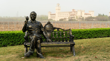 Statue of a man drinking wine