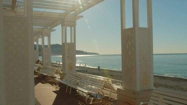 4K French Riviera pergola benches in Nice with beautiful view of the beach and coastline
