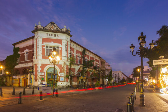 Semarang - Indonesia, April 5, 2025 : View of The Marba Building in Kota Lama Semarang, stands prominently at dawn. Its historic architecture, featuring red brick and white accents.