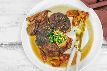 Ossobuco beef meat with spices and fresh herbs. Veal shank steak, traditional Italian ingredient