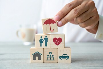 Concept of insurance and protection illustrated with wooden blocks depicting family, health, home, car, and umbrella symbols