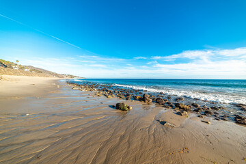 Beach in Malibu under a blue sky