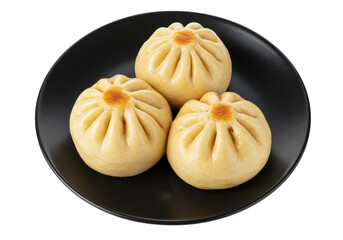 Three freshly steamed buns on a black plate, highlighting their fluffy texture and golden center