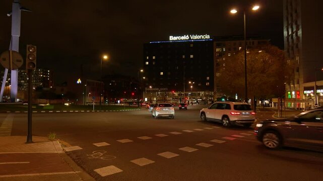 Night traffic flowing at barcel&oacute; valencia hotel intersection
