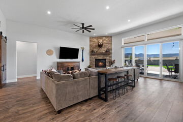 A living room with a couch, TV, fireplace, and sliding doors