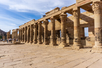 Fototapeta premium Ancient Temple of Isis at Philae on the Nile River in Aswan Egypt with Columns and Hieroglyphs under a Clear Blue Sky in Archaeological Site