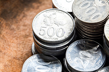 Close-Up of Shiny Indonesian Rupiah Coins. Focus on 500 and 1000 Rupiah