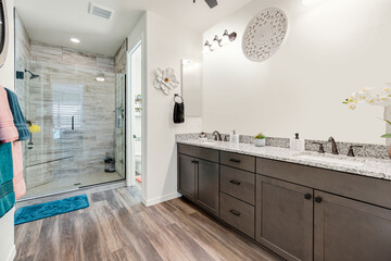 This is a spacious bathroom featuring two sinks and a walkin shower