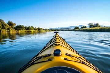 Kayak on tranquil river, trees lining the bank, mountains in distance