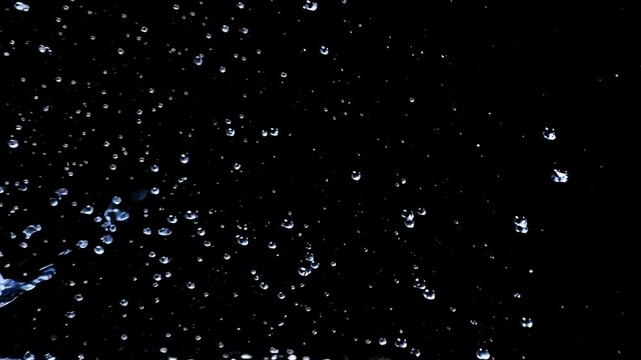 Ephemeral Dance of Droplets: A mesmerizing display of water droplets suspended against a dark, velvety canvas. The image captures a transient moment of pure, ethereal beauty.