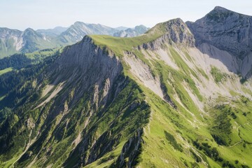 Mountainous ridge with lush green slopes under a clear sky backdrop