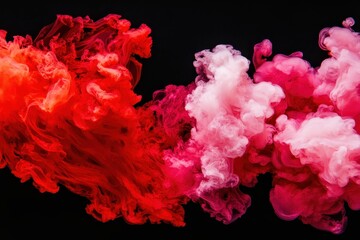 Obraz premium Vibrant swirls of red and pink smoke against a black background create a striking visual contrast and dynamic energy.