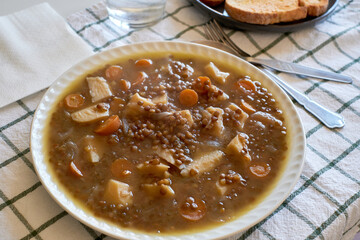 Delicious Lentil Soup Served With Crunchy Toasted Bread on a Checkered Tablecloth