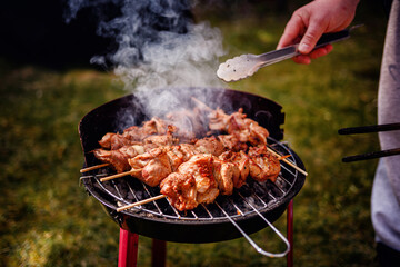 Grilling Meat Skewers Over Hot Charcoal at Outdoor BBQ
