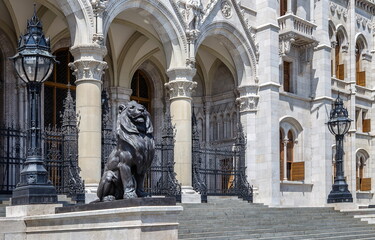 lion statue at the entrance to the building of hungarian parliament