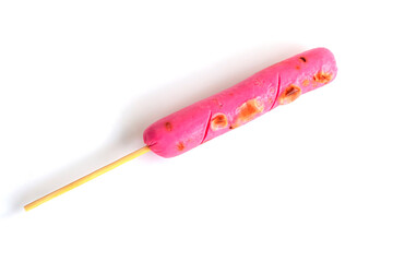 Grilled pink sausages on a stick on white background
