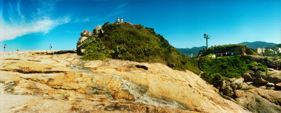 People on boulders that separate Copacabana and Ipanema beach, Rio de Janeiro, Brazil.