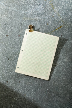 Blank pale green graph paper angled on magnet board